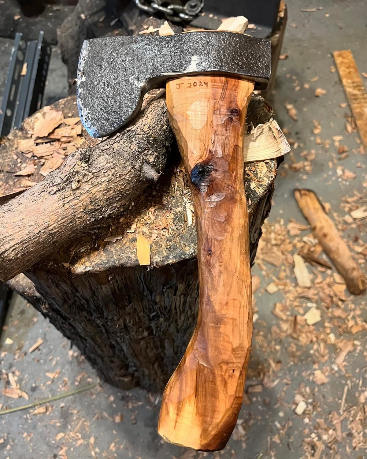 Hand-forged knife being used for bushcraft in nature